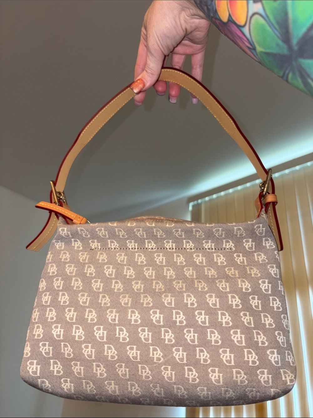 Dooney & Bourke Signature logo canvas hobo shoulder bag with a leather strap